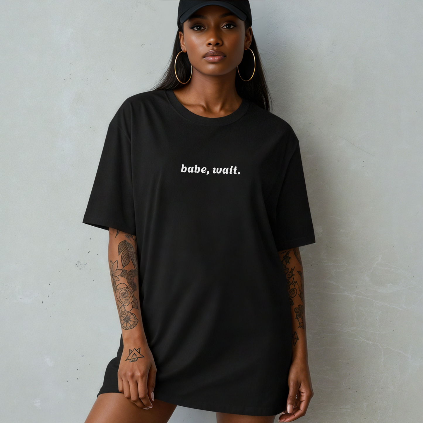 Woman wear black tshirt that says 'babe, wait'
