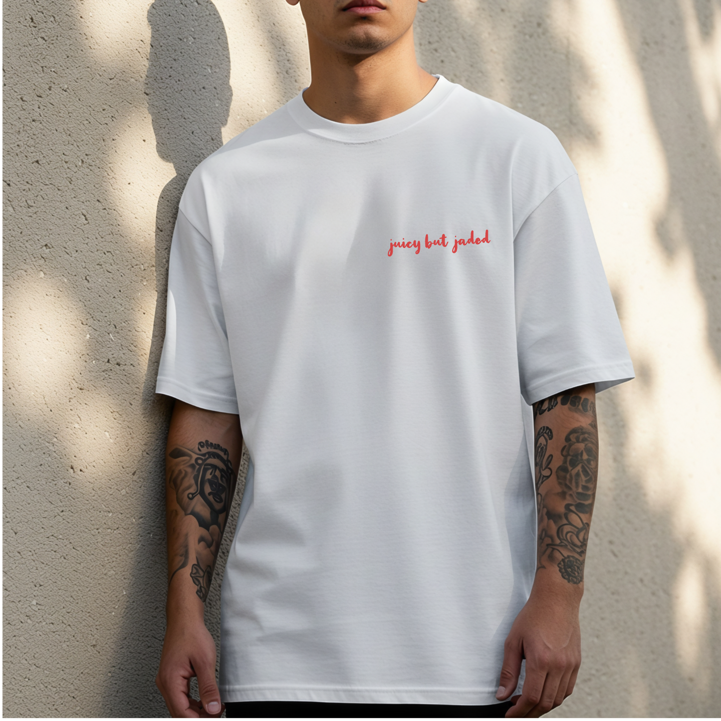 Front of model wearing white tshirt with saying 'juicy but jaded'