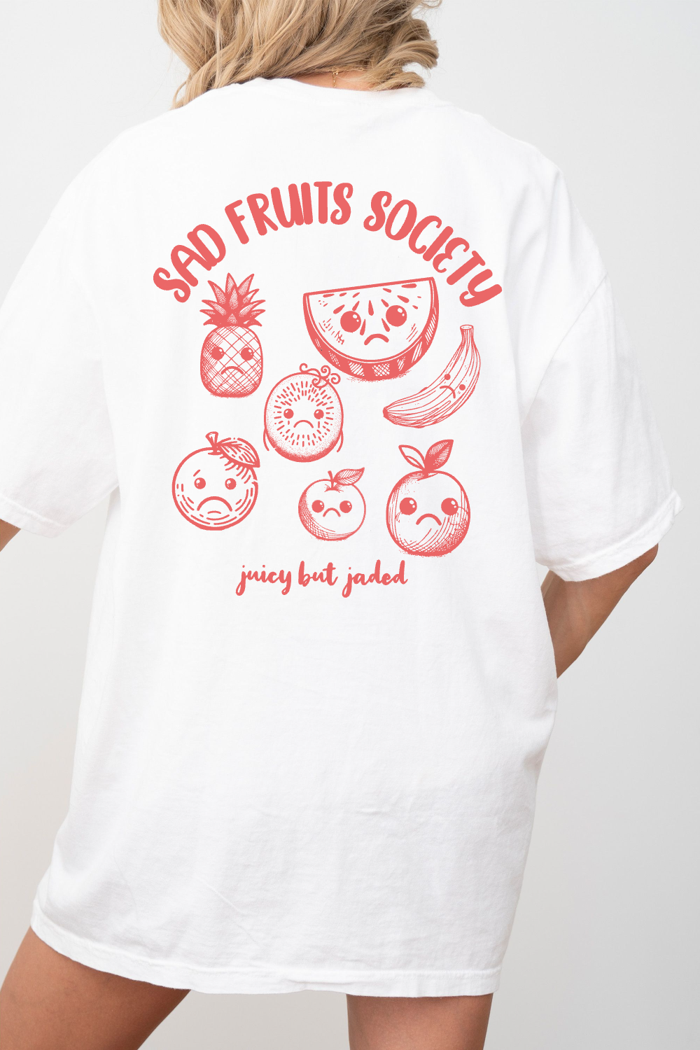 Back of model wearing white tshirt with tropical fruits with sad faces