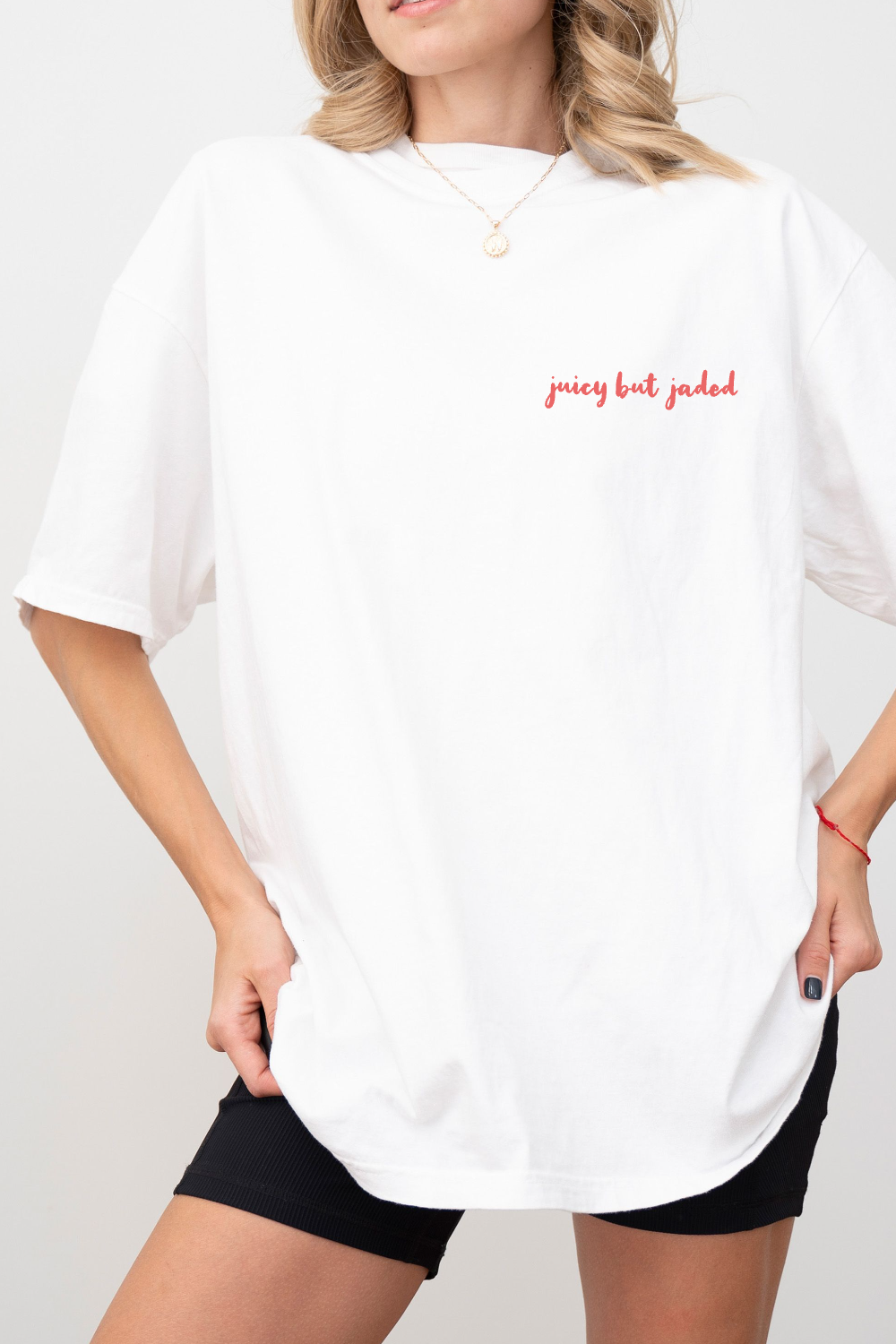 Front of model wearing white tshirt with saying 'juicy but jaded'