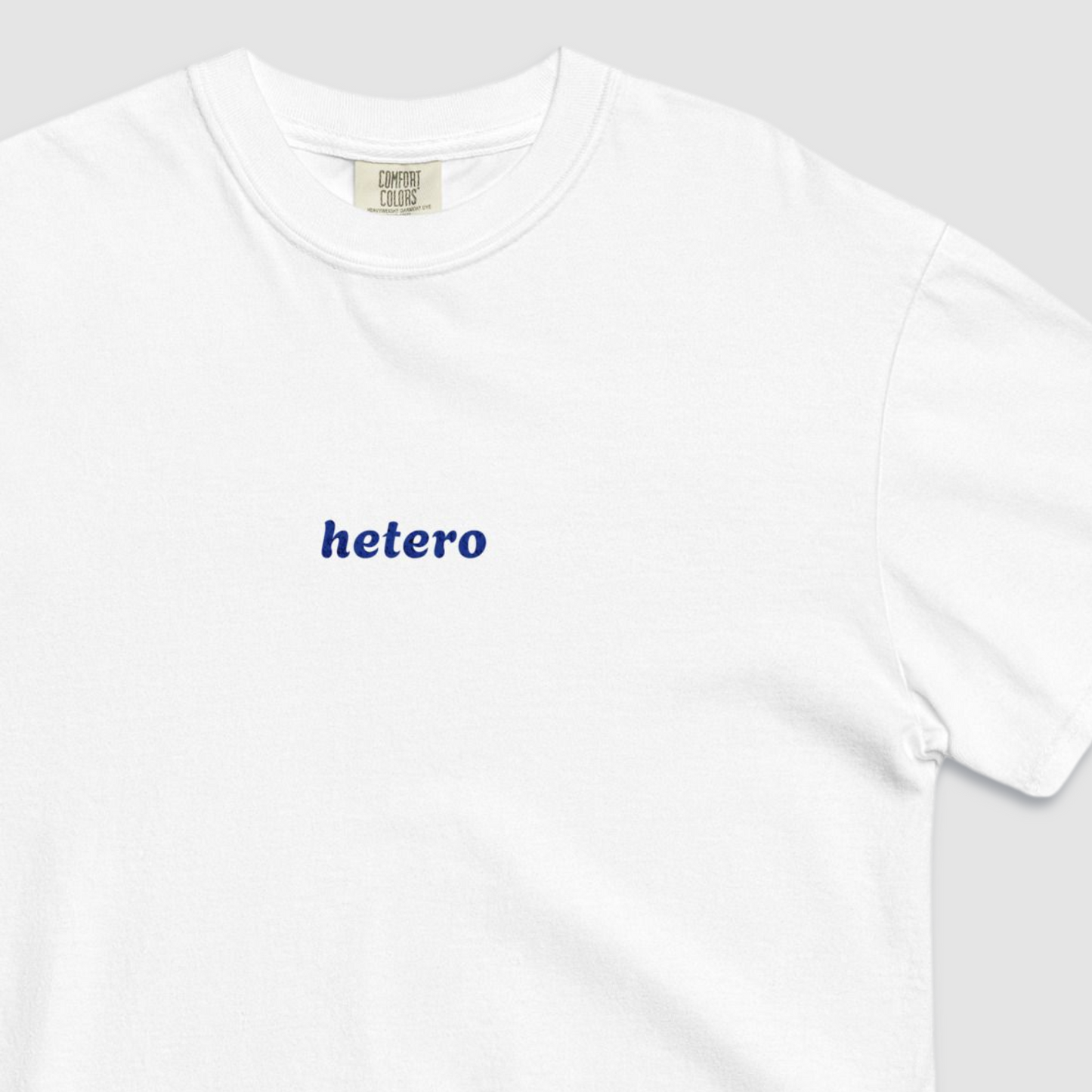 Close up of white tshirt with hetero text written in blue across the chest