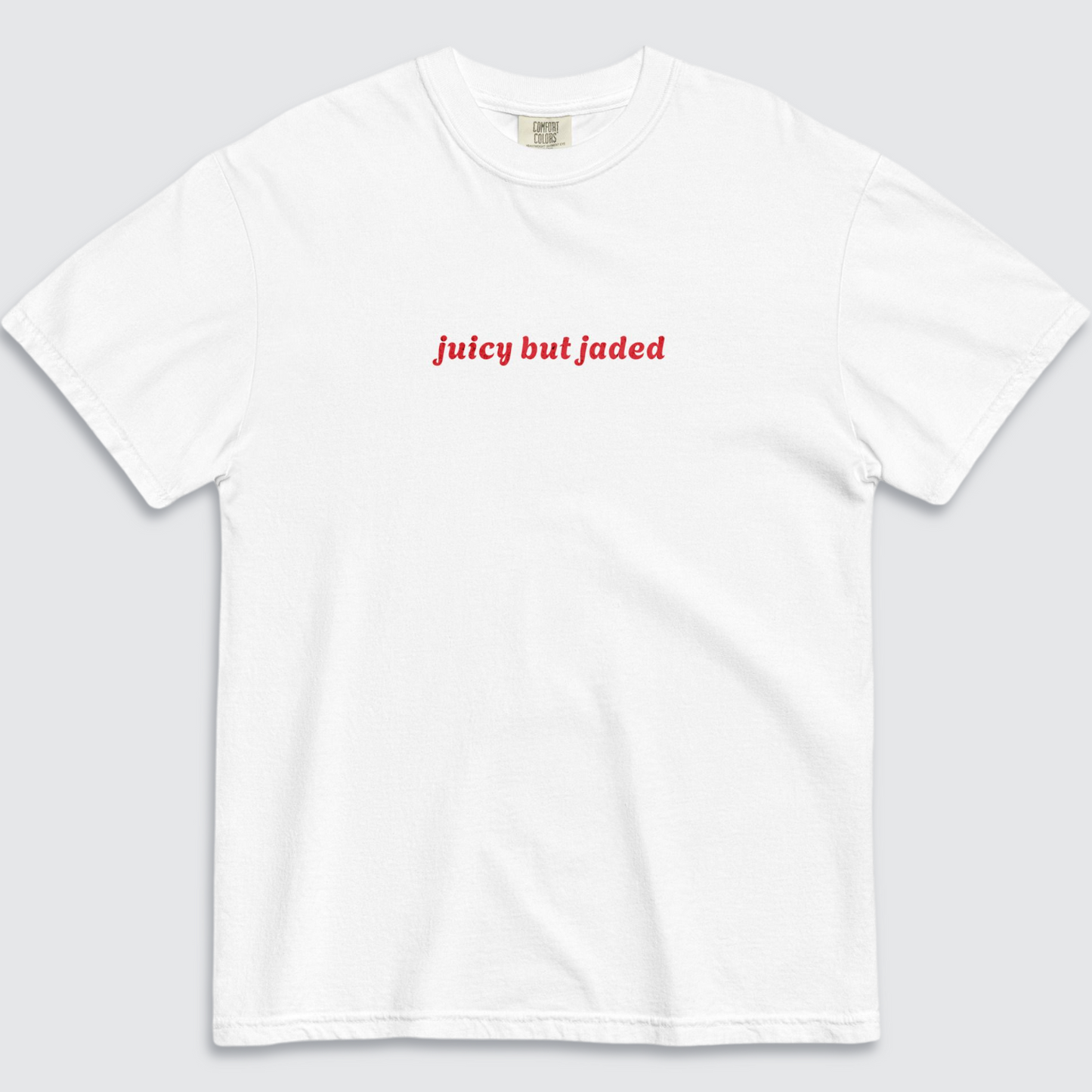 White tshirt with text 'juicy but jaded' written across the chest in red