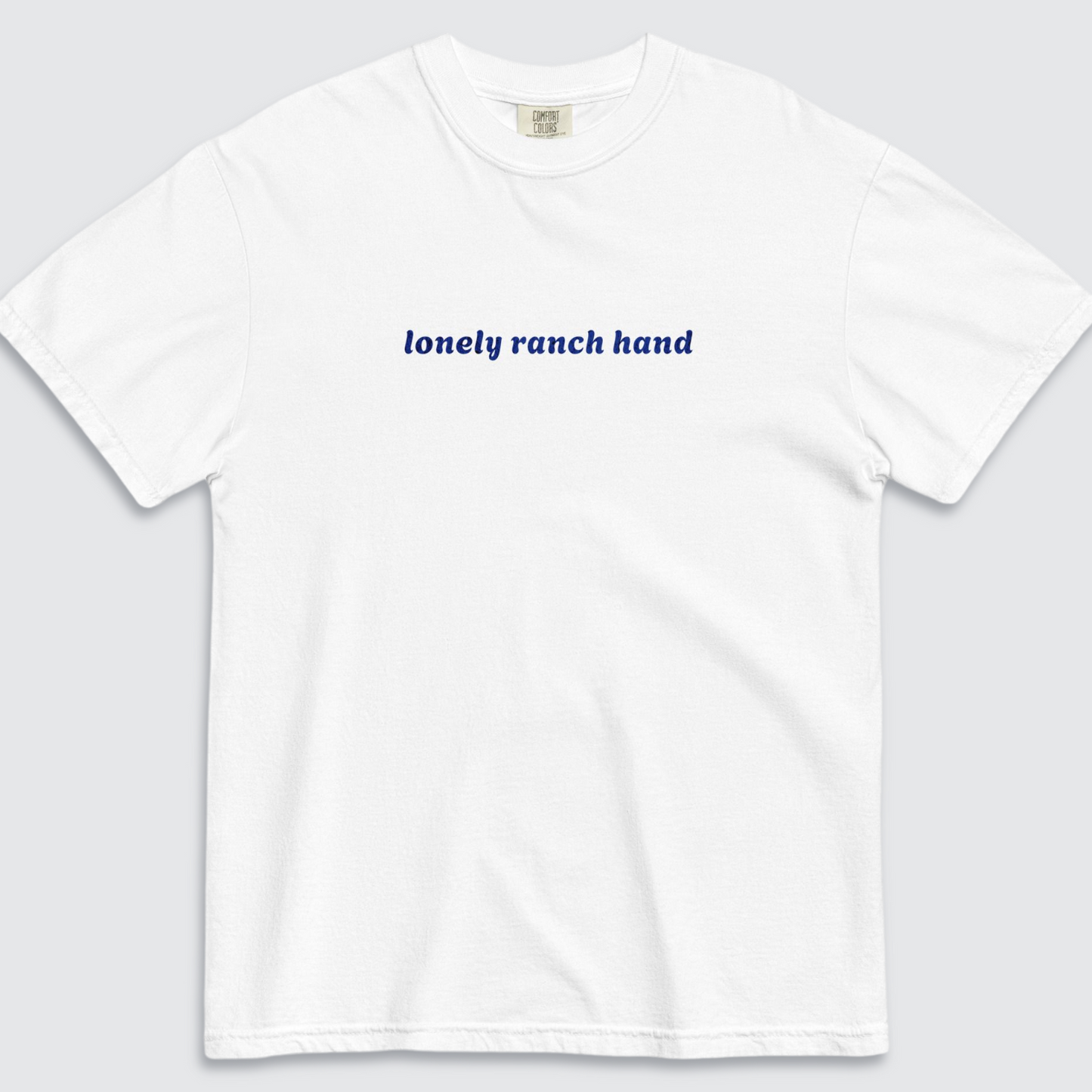 White tshirt with 'lonely ranch hand' text written in blue across the chest