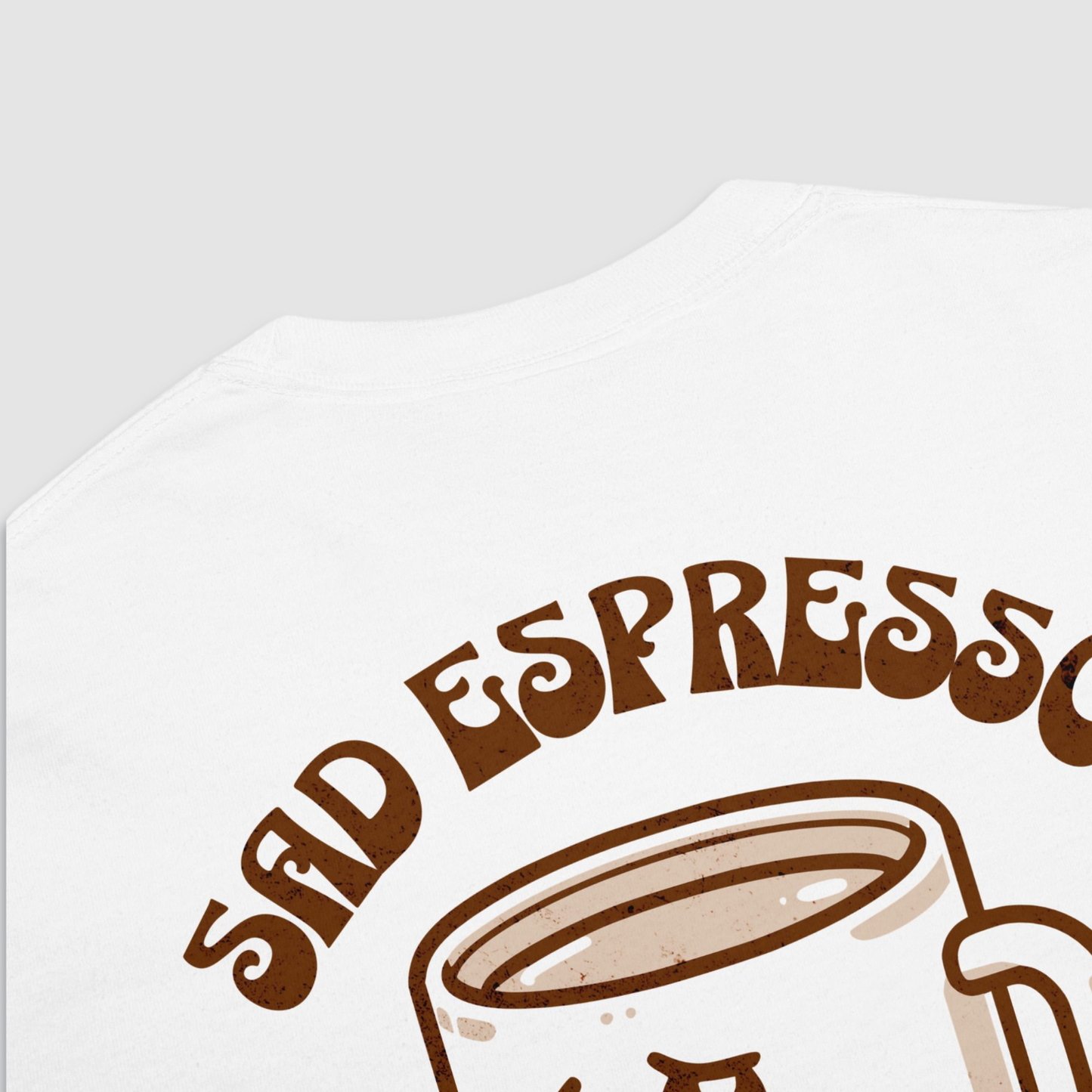 Close up of the back of white tshirt with a graphic of a sad espresso cup with 'sad espresso' written above it