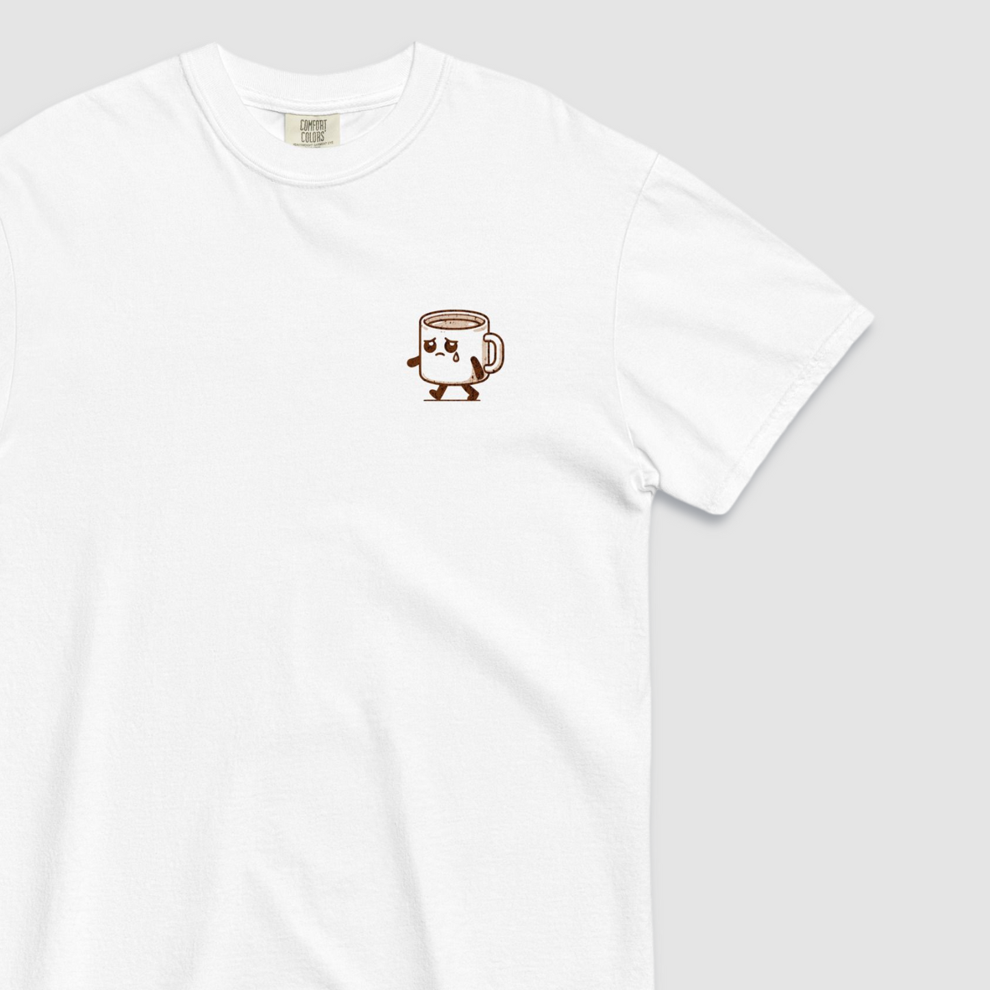Close up of front of white tshirt with a graphic of a sad espresso cup with 'sad espresso' graphic on the front left chest
