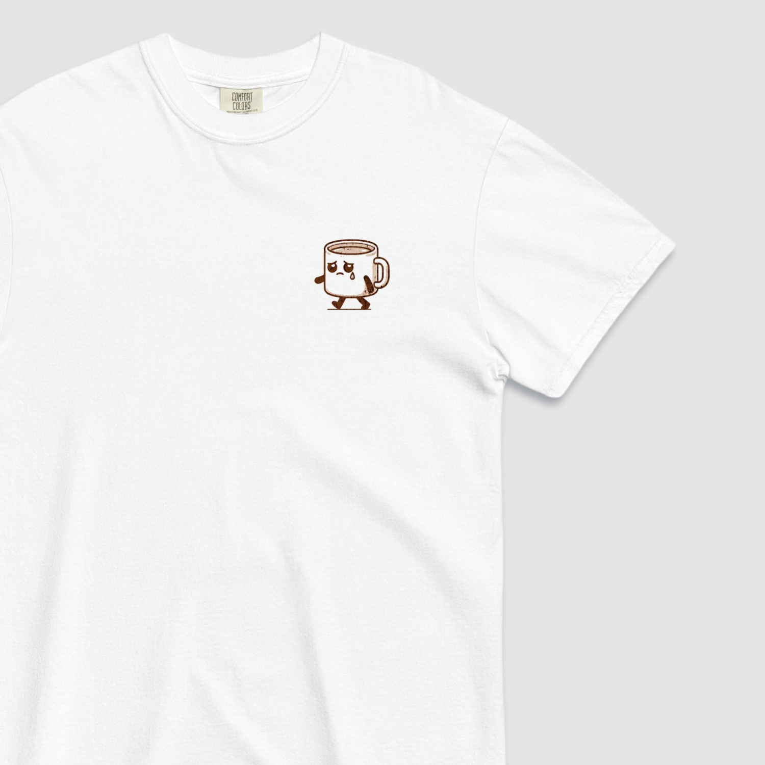 Close up of front of white tshirt with a graphic of a sad espresso cup with 'sad espresso' graphic on the front left chest